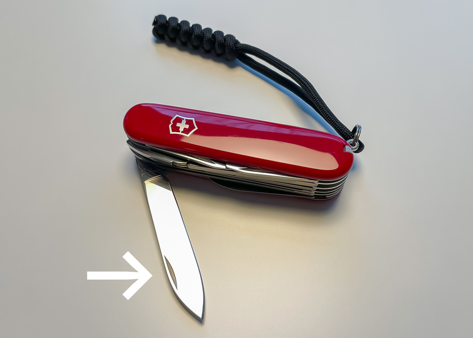 A Swiss Army Knife showing the nail nick in the main blade.